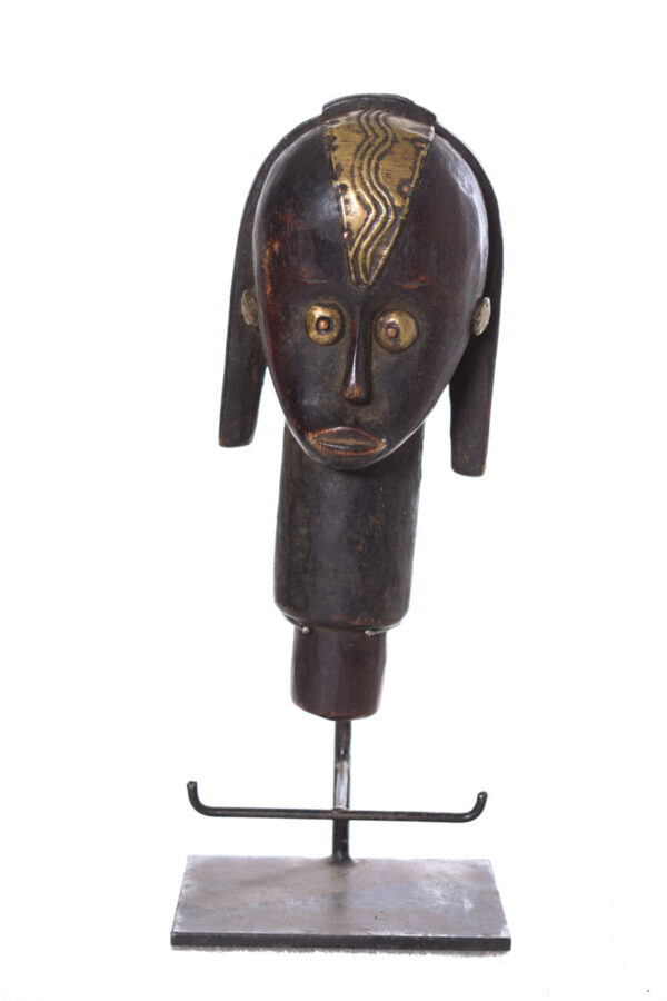 The wooden head is decorated with copper strips.
