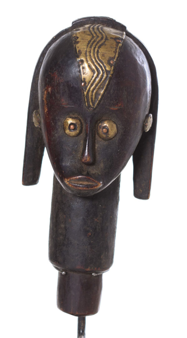 The wooden head is decorated with copper strips.