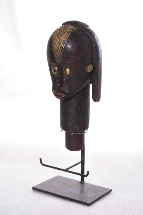 The wooden head is decorated with copper strips.