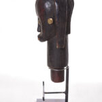 The wooden head is decorated with copper strips.