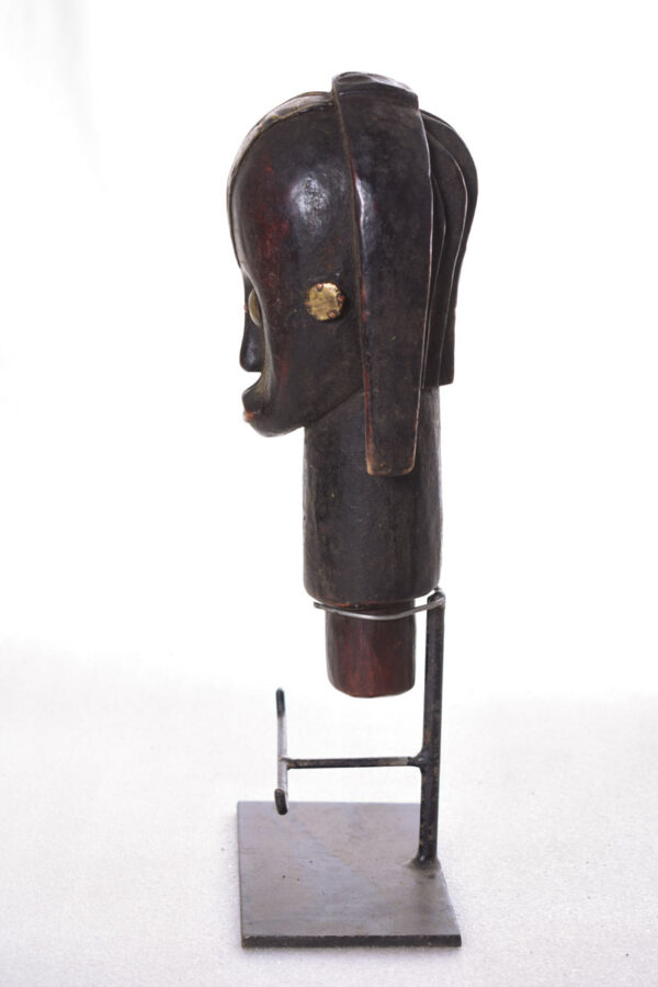 The wooden head is decorated with copper strips.