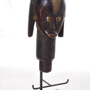 The wooden head is decorated with copper strips.