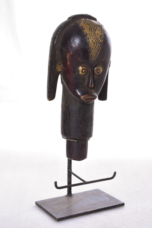 The wooden head is decorated with copper strips.