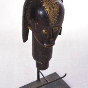 The wooden head is decorated with copper strips.