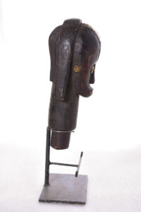 The wooden head is decorated with copper strips.