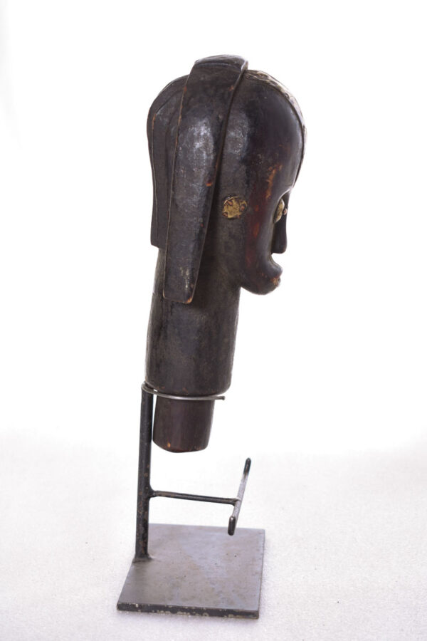 The wooden head is decorated with copper strips.
