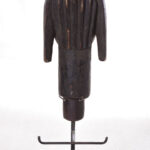 The wooden head is decorated with copper strips.